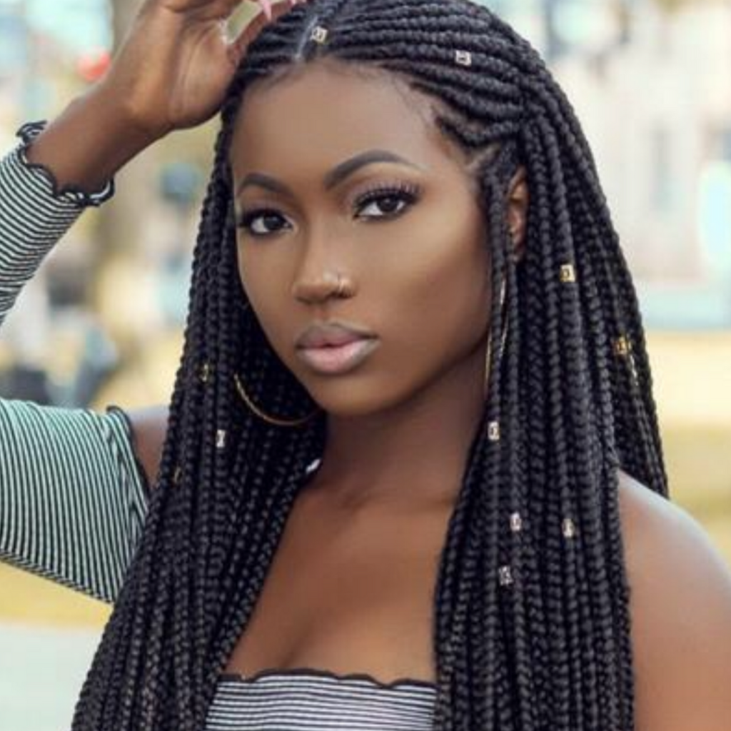 Ghanian braids adorned in an intricately styled hairdo