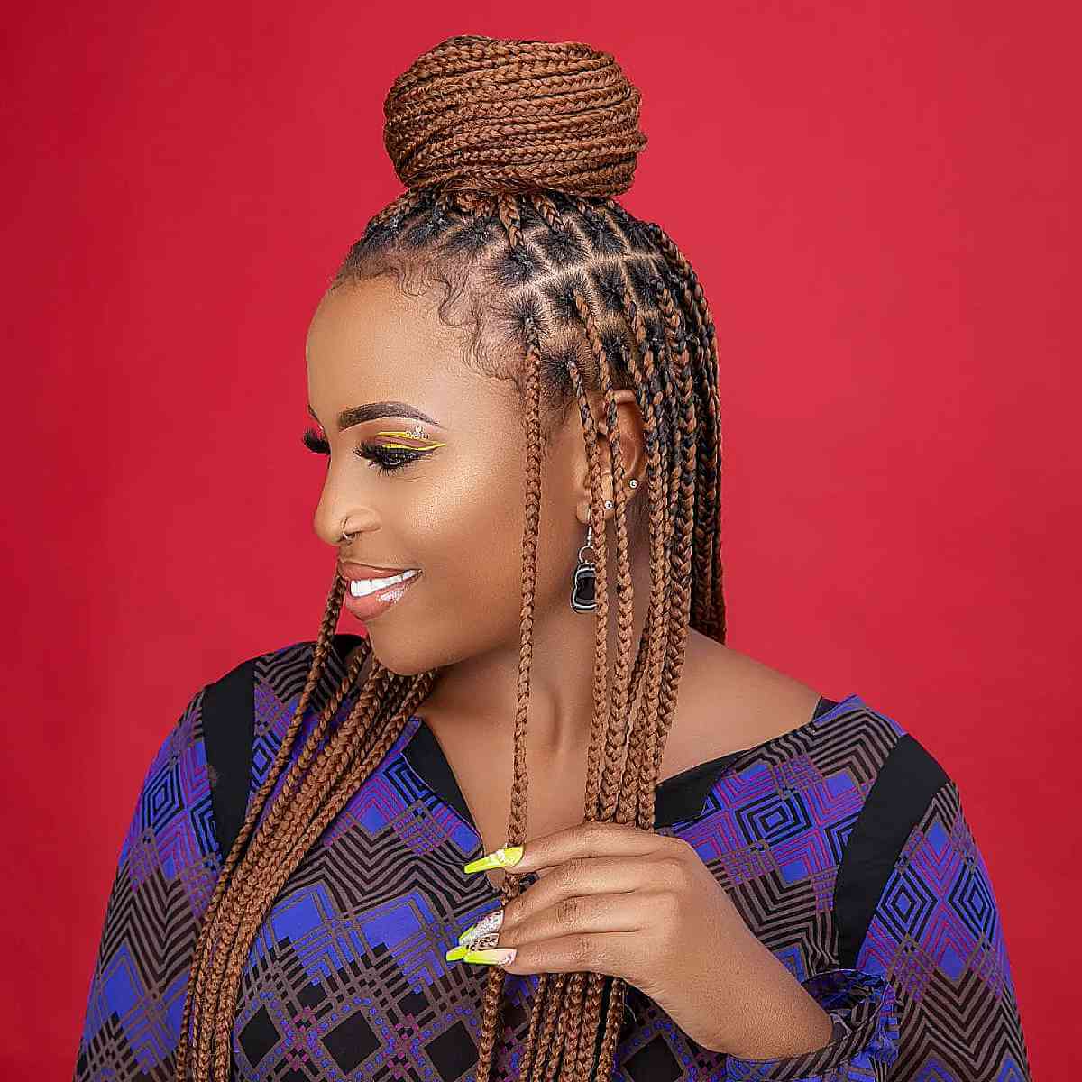 golden long box braids with a high bun